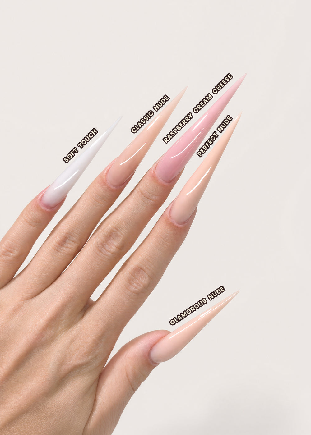 Nail art display with long, pointed nails painted in various shades of pink on a neutral background.
